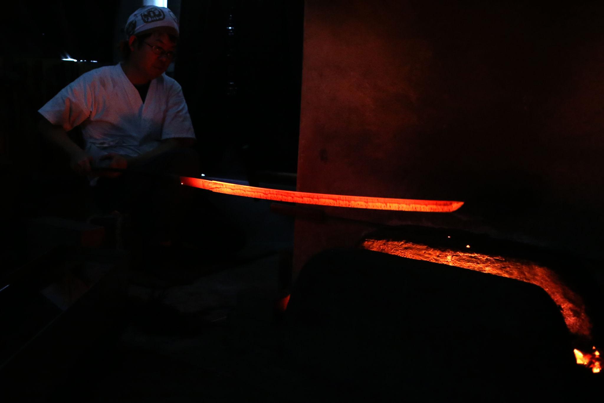 Red hot Japanese katana blade heated in forge before heat treatment