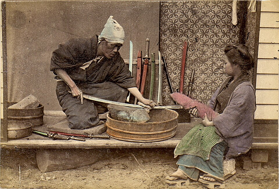 Japanese sword sharpener using traditional whetstone in 1909 Japanese sword sharpener using traditional whetstone in 1909