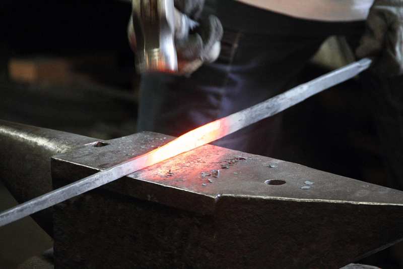 Hand forged functional sword with carbon steel blade construction