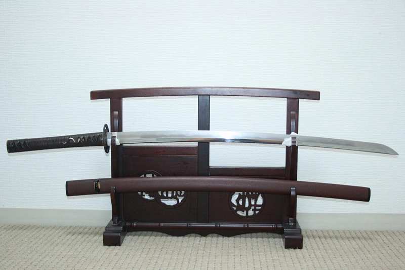 Japanese katana stored safely on a traditional sword stand Japanese katana stored safely on a traditional sword stand