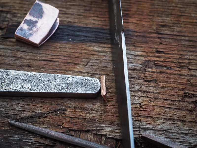 Craftsman making a traditional Habaki for Japanese sword blade Craftsman making a traditional Habaki for Japanese sword blade