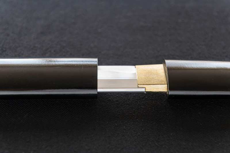 Japanese sword Habaki fitting into saya scabbard opening Japanese sword Habaki fitting into saya scabbard opening