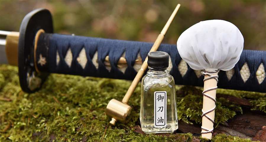 Japanese Katana sword oil maintenance with cleaning cloth and choji oil